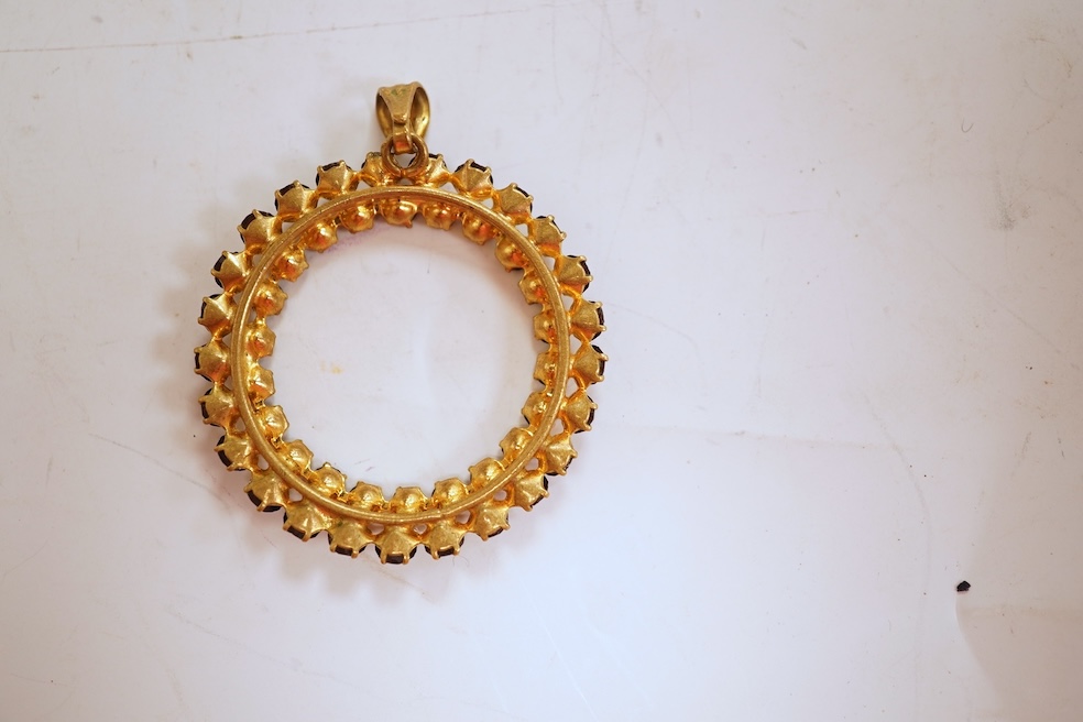 Two necklaces, comprising: a three-strand cultured pearl necklace, to a cabochon garnet and diamond clasp, length 34cm; and a paste and gilt metal pendant on a gold chain, chain length 44cm, stamped 14K, gross weight of
